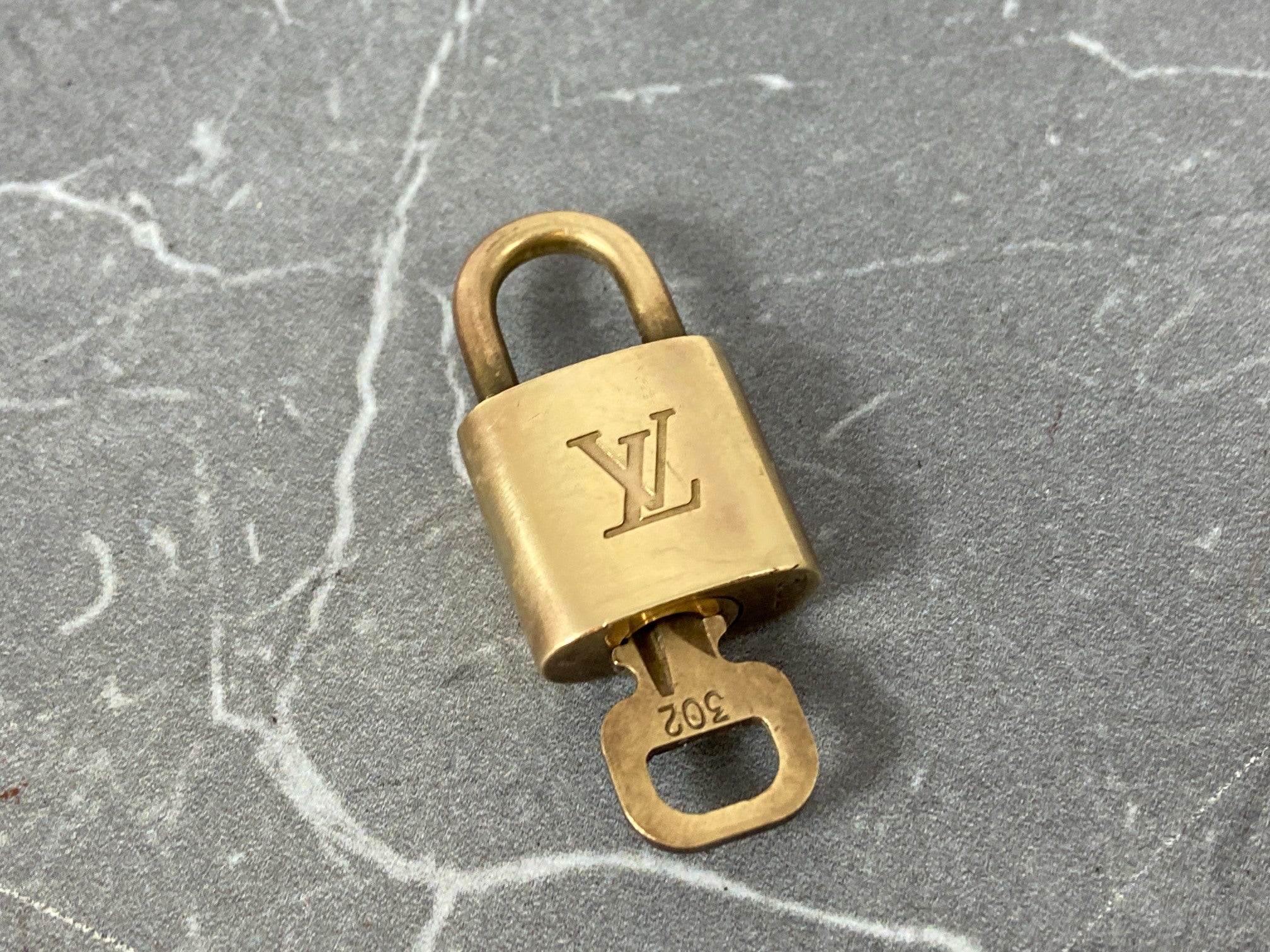 Louis Vuitton 2 Locks & 1 Key Gold Tone No. 302